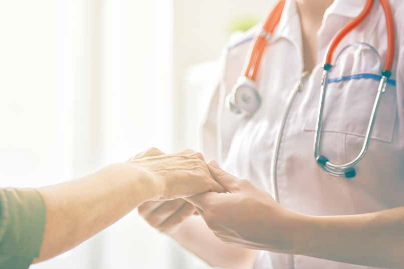 a doctor holding a patient's hand