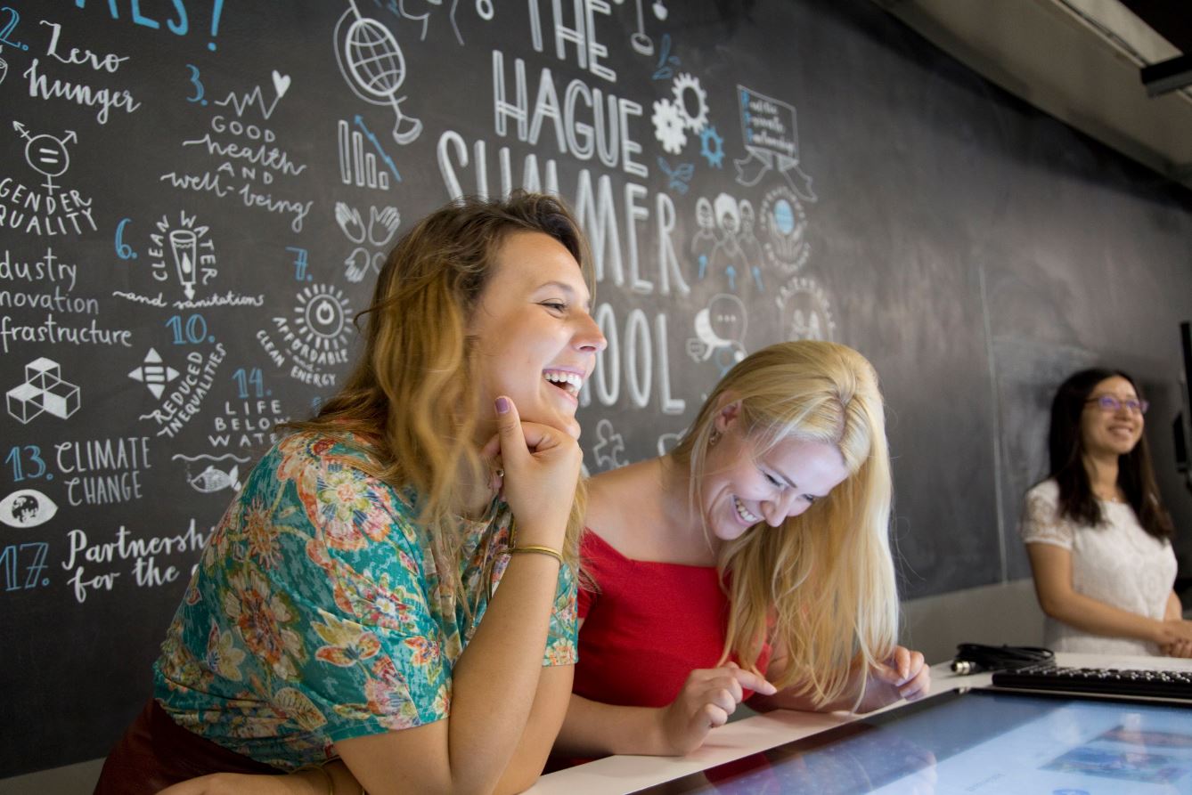 Three girls sitting in the innovation playground classroom